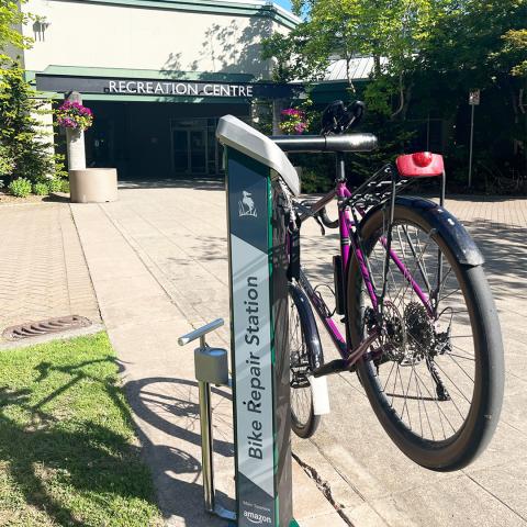 Bike Repair Station with a bike on it in front of Pitt Meadows Rec Centre